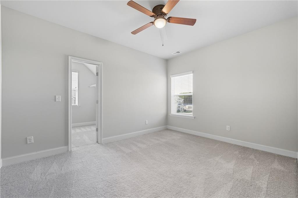 33 North Village Circle Rydal, GA 30171 - Photo 28 of 48 an empty room with a ceiling fan and a window