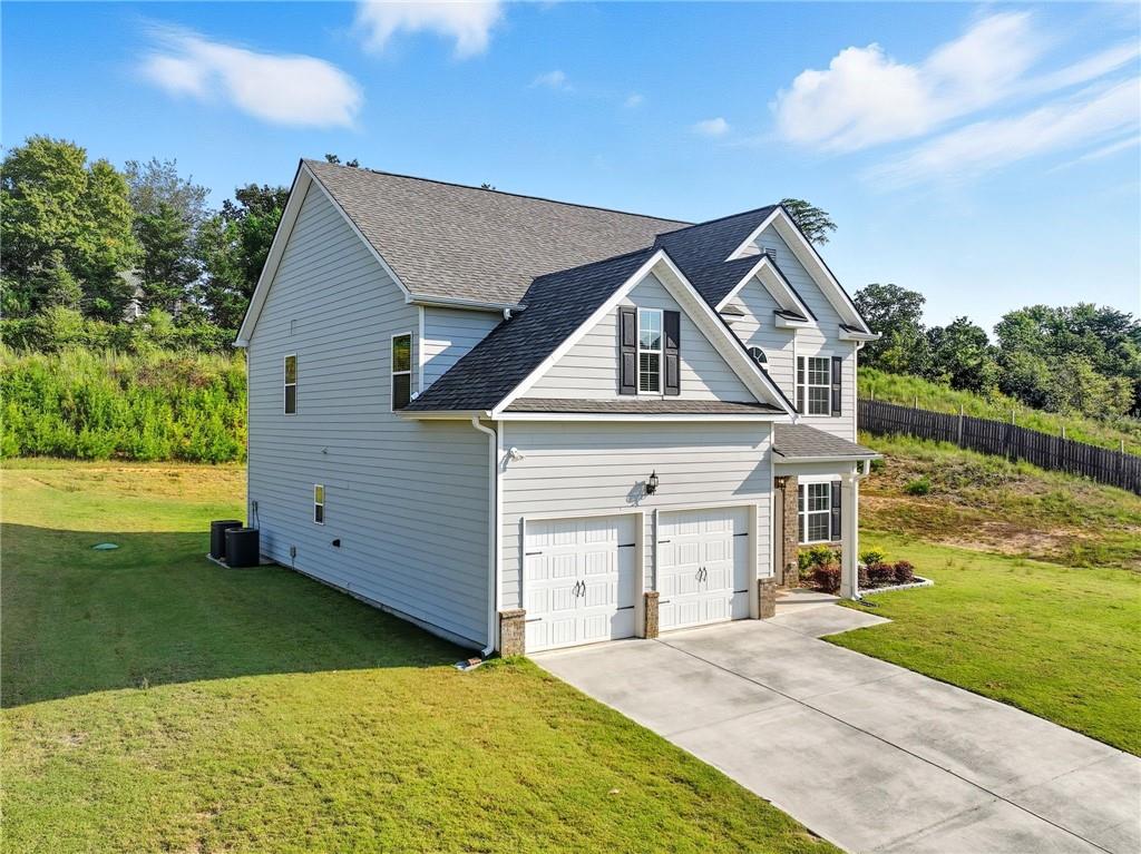 33 North Village Circle Rydal, GA 30171 - Photo 32 of 48 a front view of a house with a yard and garage
