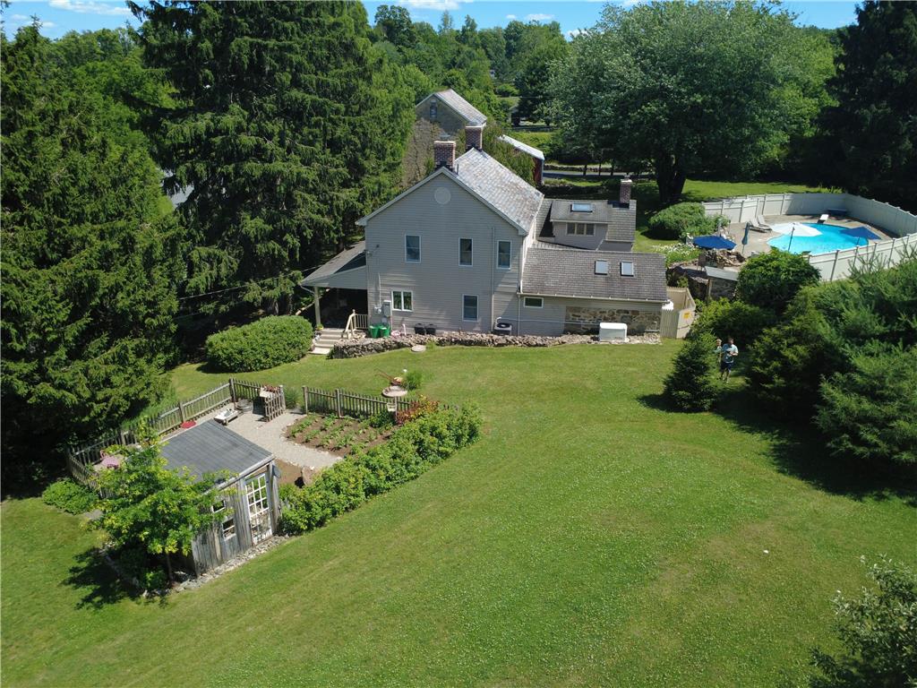 585 Buttermilk Road Hellertown, PA 18055 - Photo 80 of 82 Perched on a verdant hillside, this property features a sparkling pool and a meticulously maintained garden.