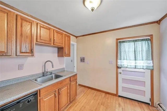 a kitchen with a sink cabinets and wooden floor