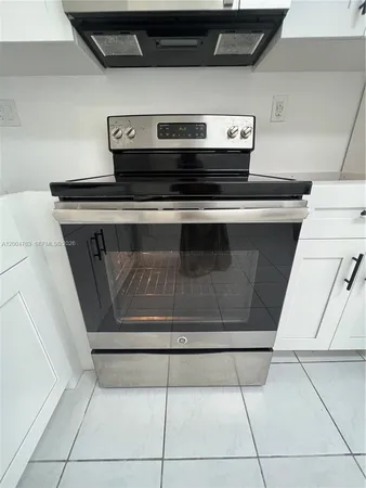 a stove top oven sitting inside of a kitchen
