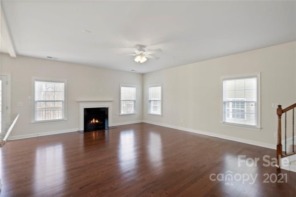 4331 Oxford Mill Road Waxhaw, NC 28173 - Photo 9 of 48 a view of empty room with fireplace and wooden floor