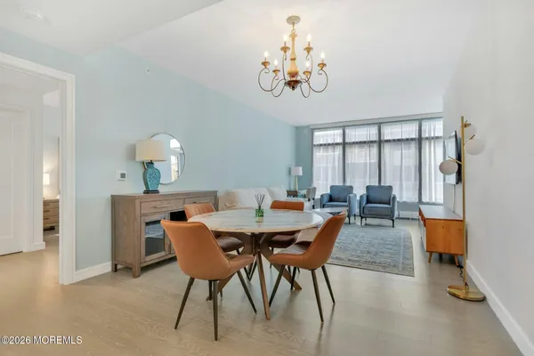 a view of a dining room with furniture and chandelier