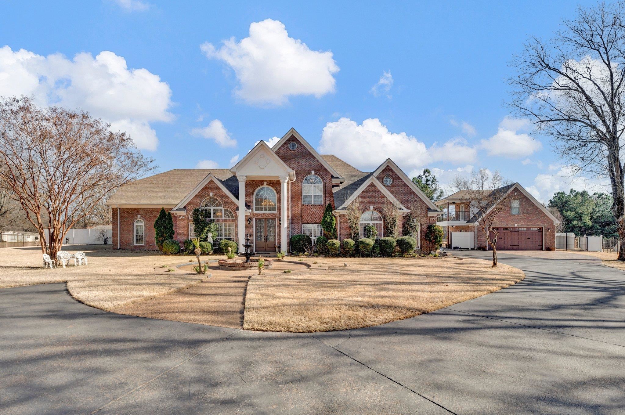 Beautiful front view with long drive and gate!