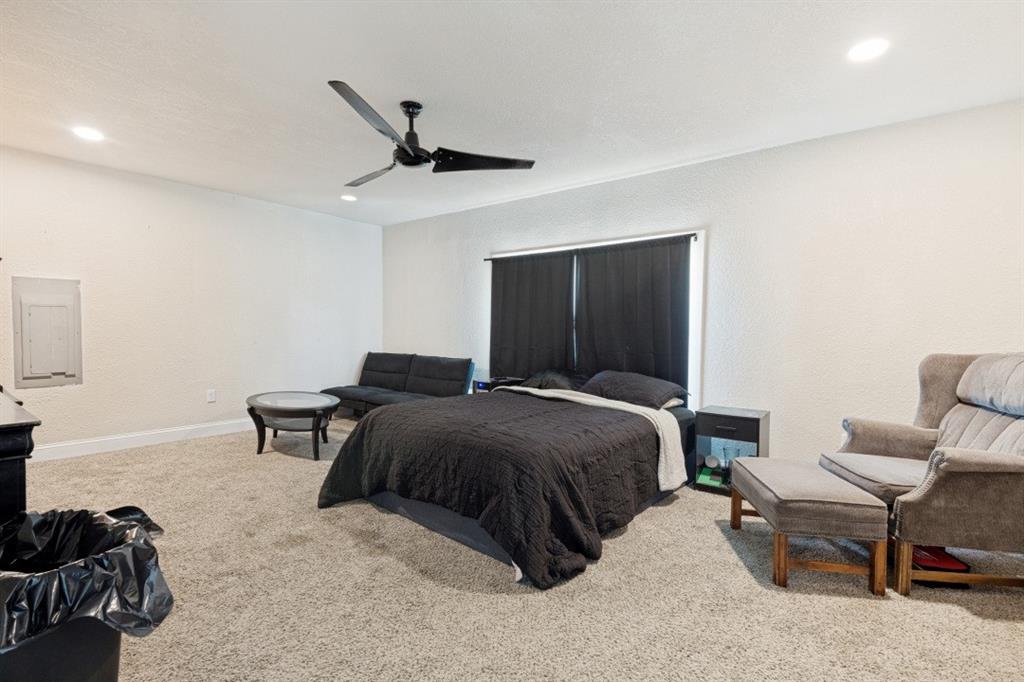 7410 Jessica Way Rowlett, TX 75088 - Photo 14 of 25 a spacious bedroom with a bed and a chair
