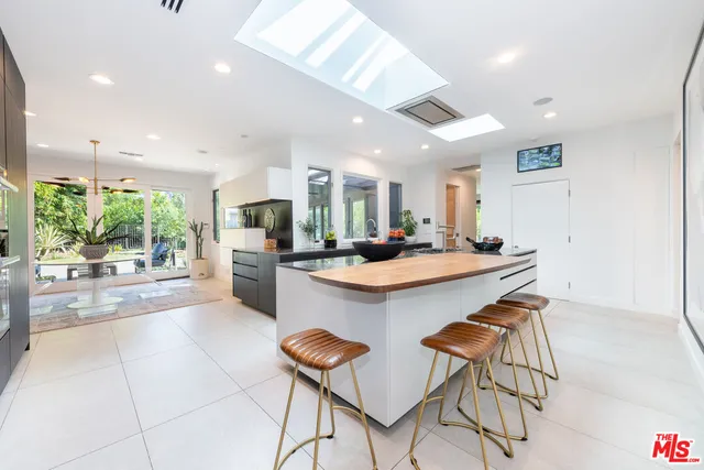a kitchen with stainless steel appliances kitchen island granite countertop a sink and cabinets