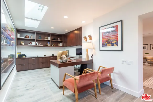 a kitchen with stainless steel appliances kitchen island granite countertop a sink and a refrigerator
