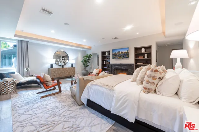 a bedroom with bed and a couch