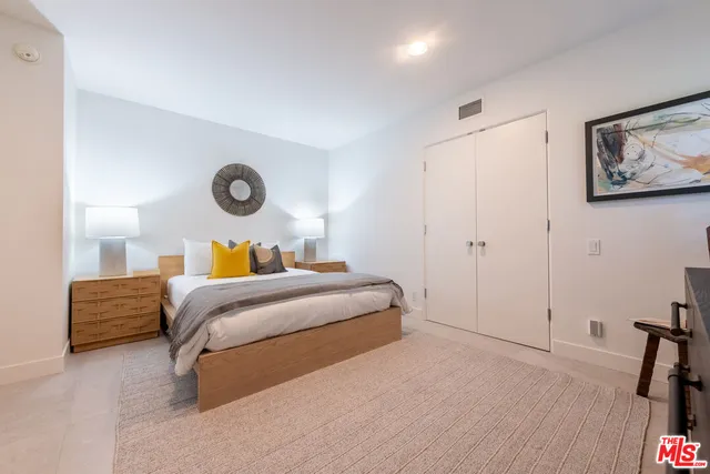 a bedroom with a bed and a chair