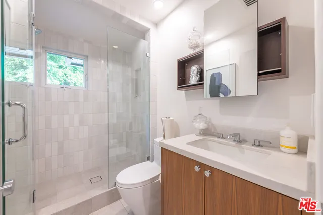 a bathroom with a sink a toilet and mirror