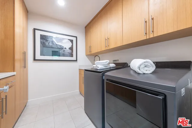 a kitchen with a sink cabinets and appliances
