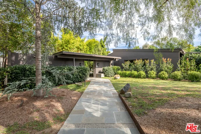 a view of house with a yard