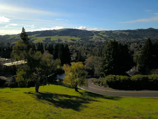 a view of a house with a yard and a large pool