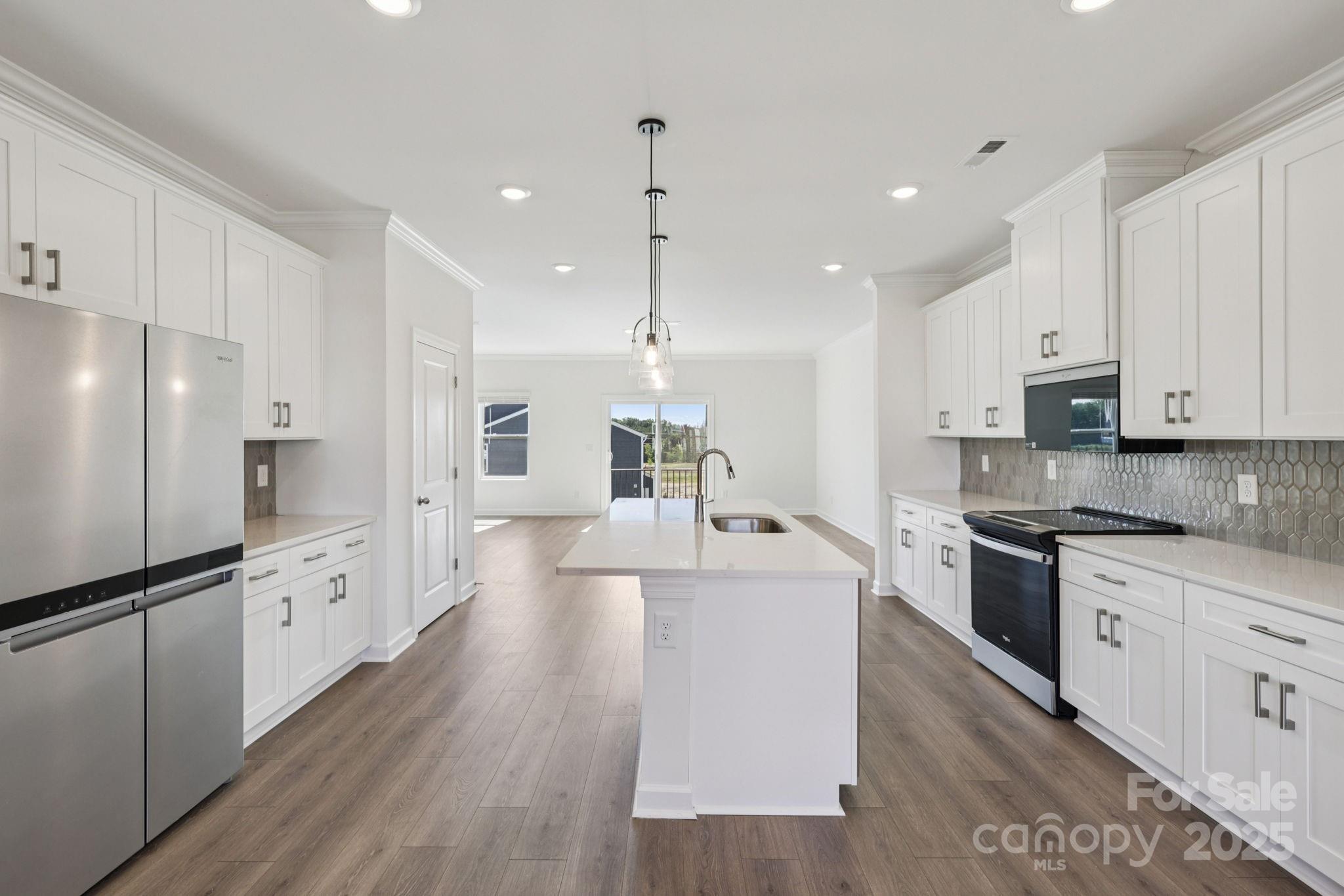 151 Kona Lane Fort Mill, SC 29708 - Photo 10 of 30 a large kitchen with stainless steel appliances lots of counter space sink refrigerator and cabinets