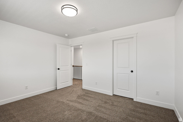1661 West Ross Road Syracuse, UT 84075 - Photo 23 of 28 Unfurnished bedroom with dark carpet and baseboards