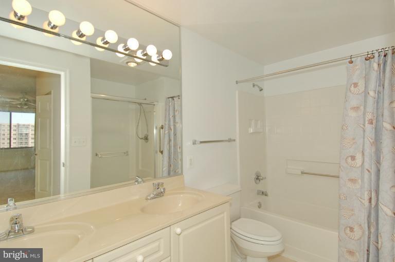 19375 Cypress Ridge Terrace, Unit 1007 Leesburg, VA 20176 - Photo 14 of 19 a bathroom with a sink a toilet and shower
