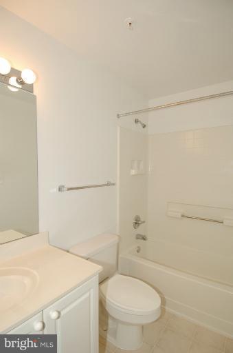 19375 Cypress Ridge Terrace, Unit 1007 Leesburg, VA 20176 - Photo 15 of 19 a bathroom with a toilet a sink and shower