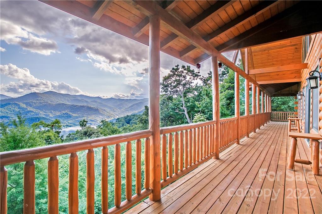 a view of balcony with wooden floor & fence