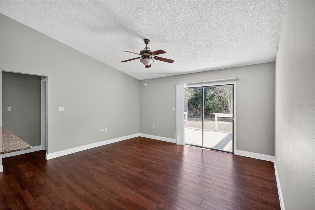 2737 East Dorchester Drive Deltona, FL 32738 - Photo 12 of 32 a view of an empty room with a window and wooden floor