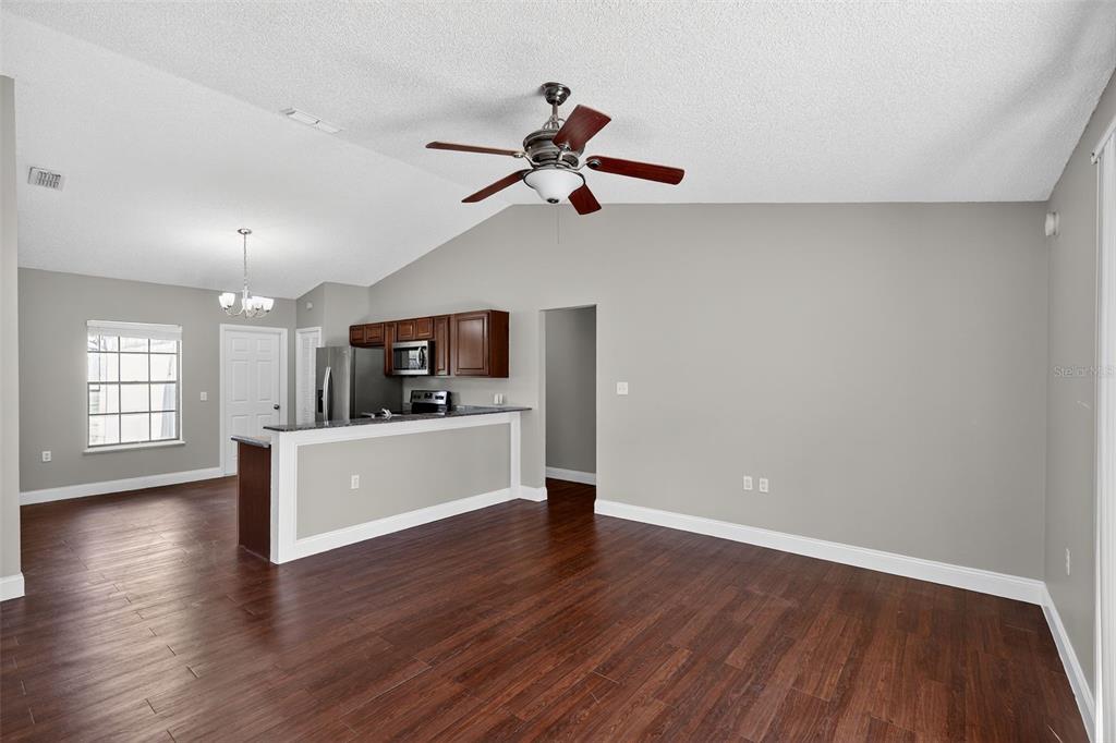 2737 East Dorchester Drive Deltona, FL 32738 - Photo 18 of 32 a view of a room with wooden floor and a ceiling fan