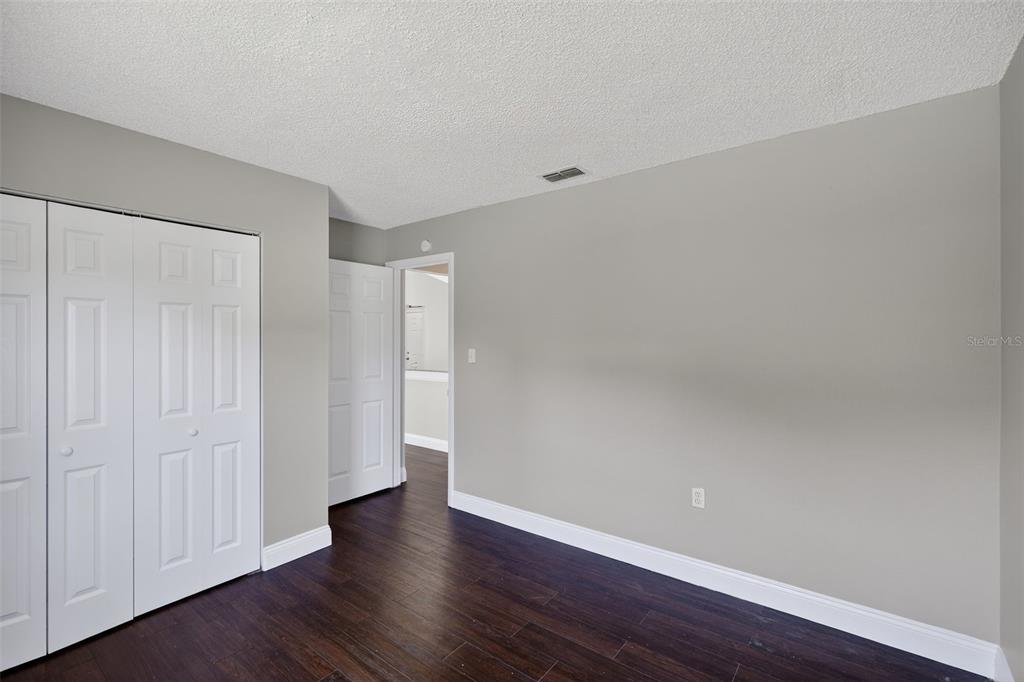 2737 East Dorchester Drive Deltona, FL 32738 - Photo 20 of 32 a view of an empty room with wooden floor