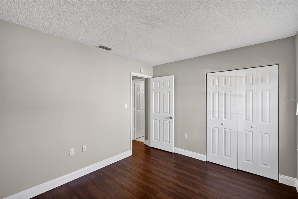 2737 East Dorchester Drive Deltona, FL 32738 - Photo 22 of 32 a view of an empty room with wooden floor
