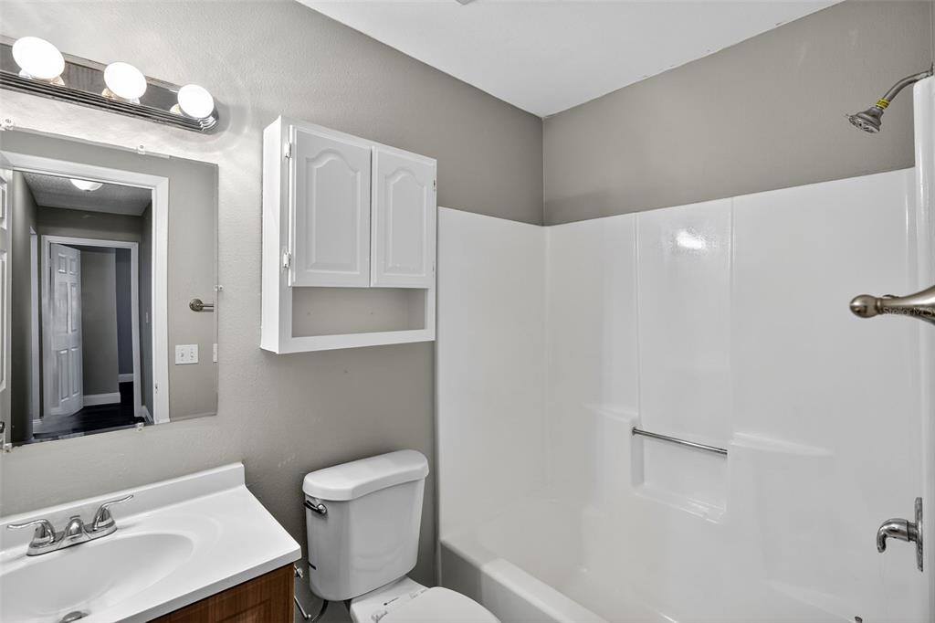 2737 East Dorchester Drive Deltona, FL 32738 - Photo 28 of 32 a bathroom with a toilet sink and mirror
