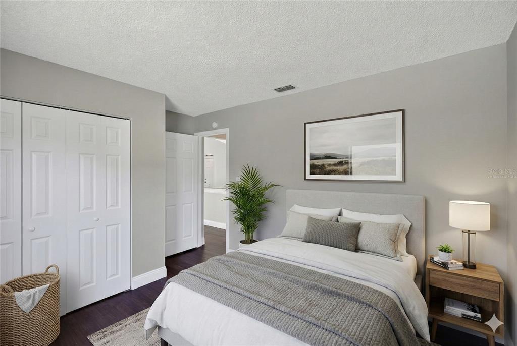 2737 East Dorchester Drive Deltona, FL 32738 - Photo 6 of 32 a bedroom with a bed and a painting on the wall