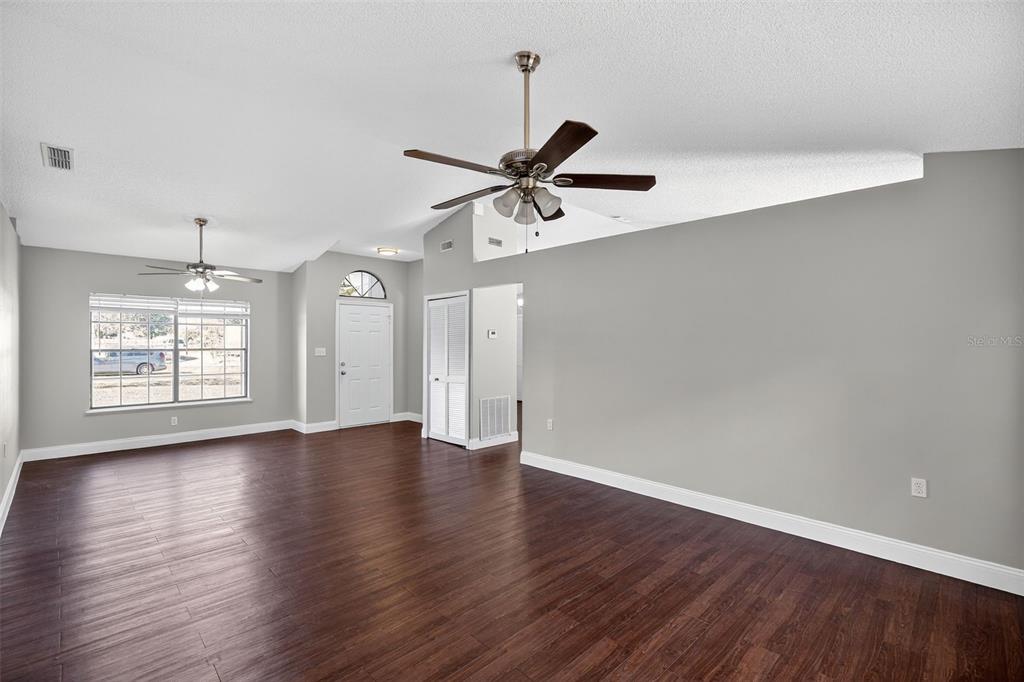 2737 East Dorchester Drive Deltona, FL 32738 - Photo 9 of 32 a view of an empty room with window and wooden floor