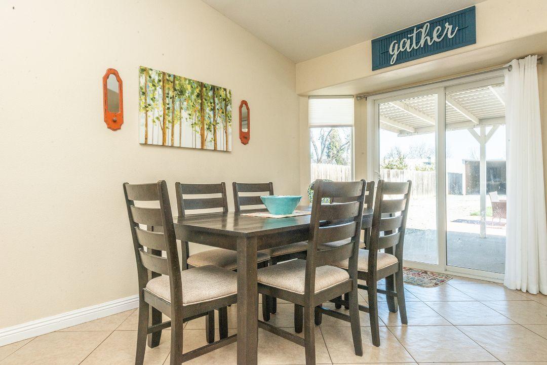 2771 North Street Anderson, CA 96007 - Photo 16 of 55 a view of a dining room with furniture and a floor to ceiling window
