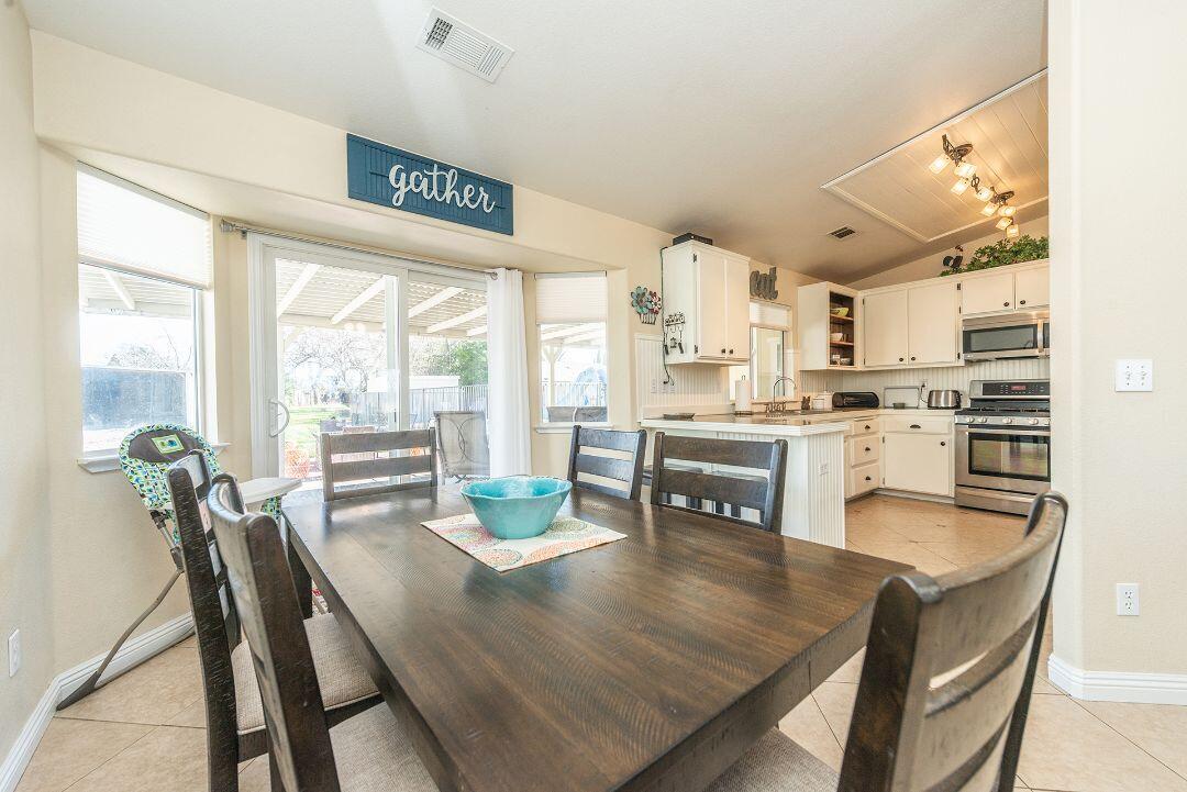 2771 North Street Anderson, CA 96007 - Photo 19 of 55 a open dining room with stainless steel appliances furniture a large window and a kitchen view