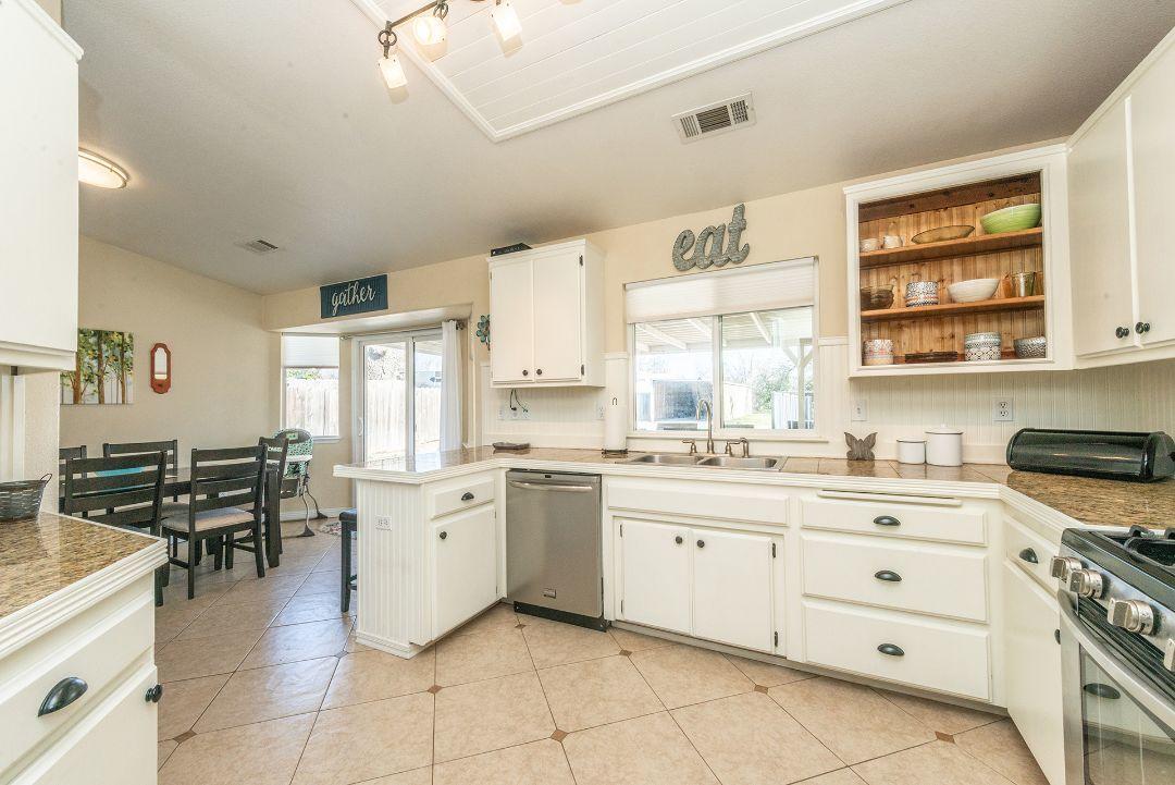 2771 North Street Anderson, CA 96007 - Photo 20 of 55 a large white kitchen with stainless steel appliances granite countertop a stove and a sink