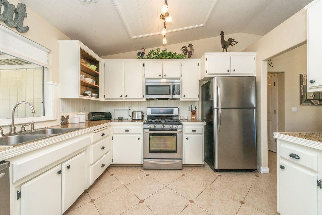 2771 North Street Anderson, CA 96007 - Photo 21 of 55 a kitchen with stainless steel appliances granite countertop a refrigerator sink and cabinets