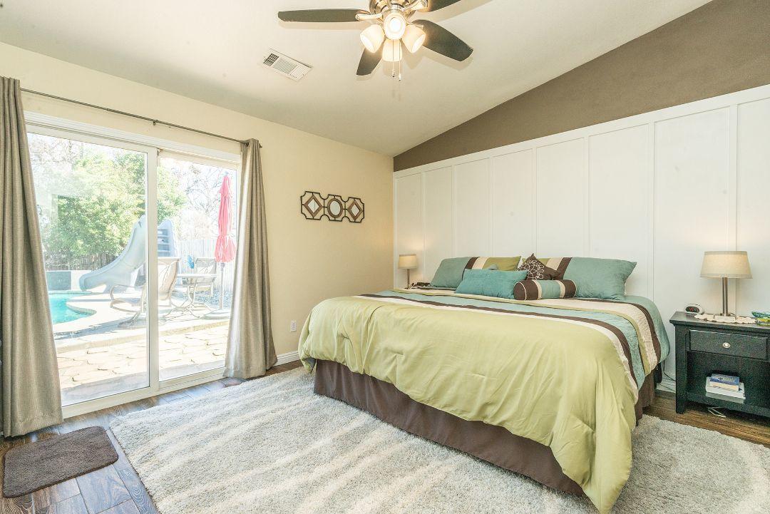 2771 North Street Anderson, CA 96007 - Photo 26 of 55 a spacious bedroom with a bed and glass window