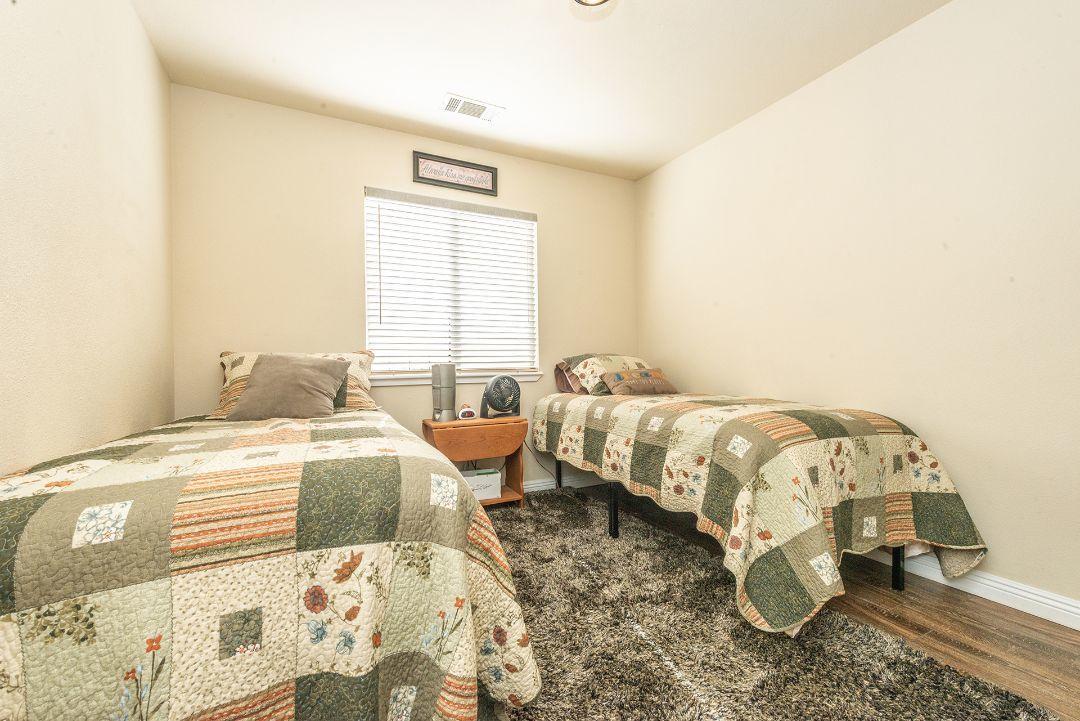 2771 North Street Anderson, CA 96007 - Photo 31 of 55 a bedroom with a bed and a couch