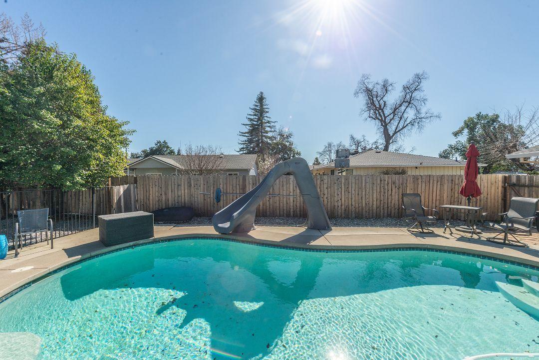 2771 North Street Anderson, CA 96007 - Photo 39 of 55 a swimming pool with lots of tress in front of it