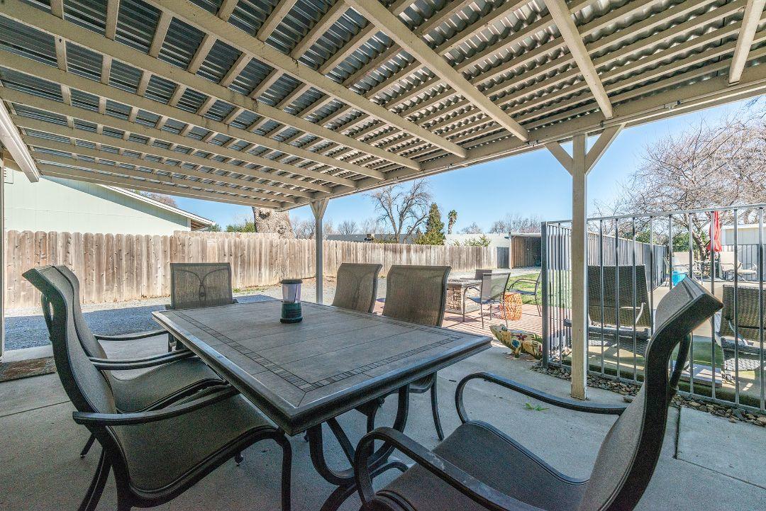 2771 North Street Anderson, CA 96007 - Photo 45 of 55 a view of a roof deck with table and chairs with wooden floor and fence