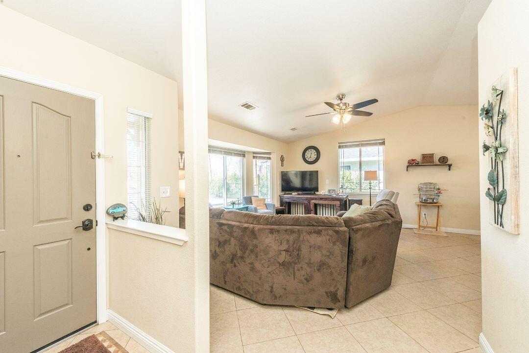 2771 North Street Anderson, CA 96007 - Photo 7 of 55 a living room with couches and a dining table with wooden floor