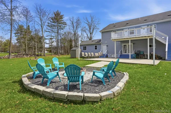 a view of a house with a yard patio and sitting area