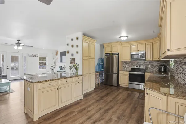 a kitchen with stainless steel appliances a refrigerator sink and cabinets