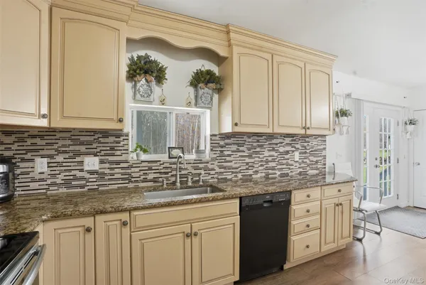 a kitchen with stainless steel appliances granite countertop a sink and cabinets