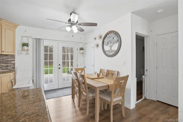 a view of a dining area with furniture and a large window