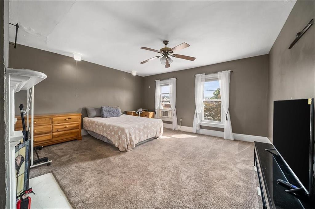 216 6th Street Monaca, PA 15061 - Photo 12 of 31 a bedroom with a bed and a flat tv screen on dresser