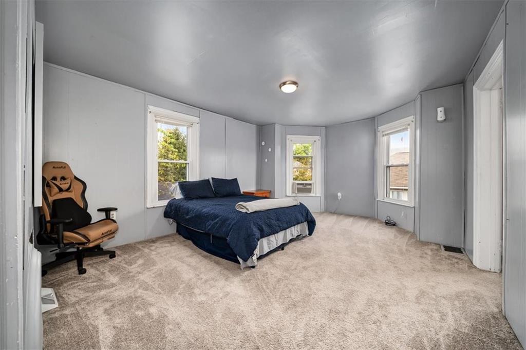 216 6th Street Monaca, PA 15061 - Photo 13 of 31 a spacious bedroom with a bed and a window