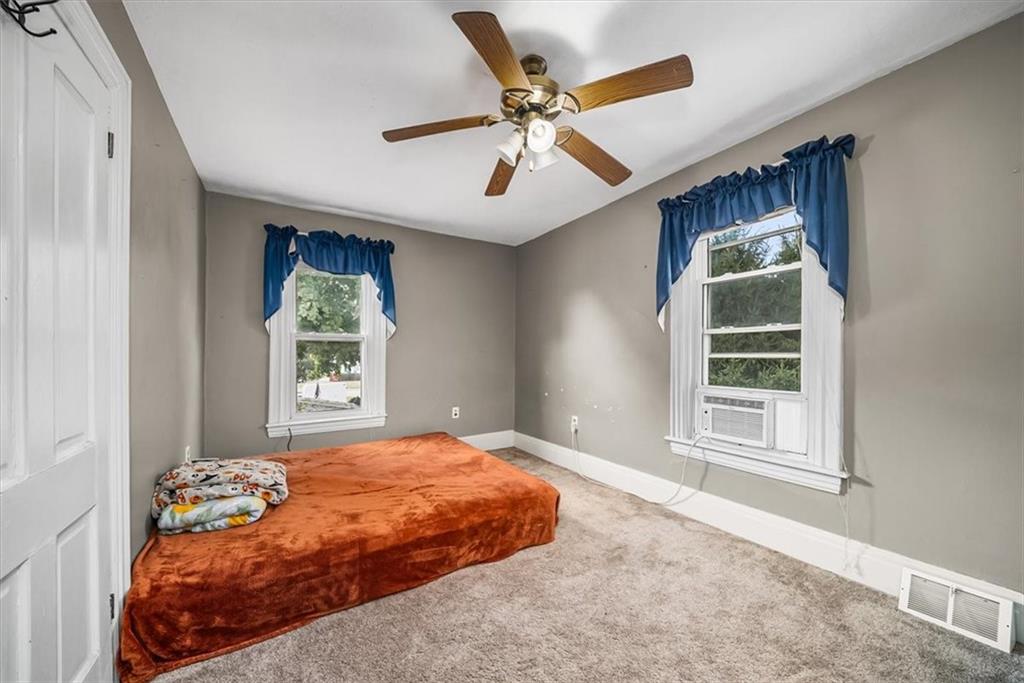 216 6th Street Monaca, PA 15061 - Photo 17 of 31 a bedroom with a bed and a window