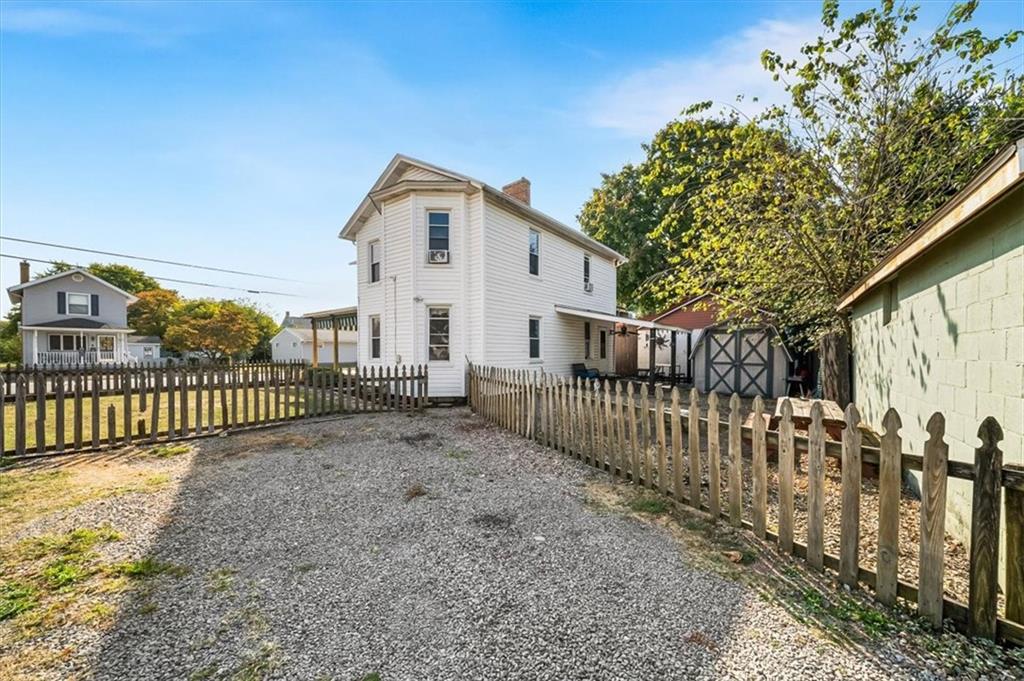 216 6th Street Monaca, PA 15061 - Photo 24 of 31 a view of a white house with large trees and wooden fence