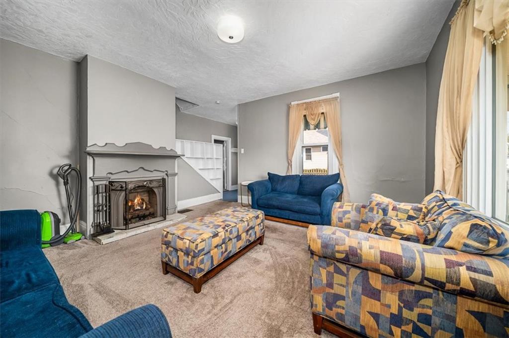 216 6th Street Monaca, PA 15061 - Photo 4 of 31 a living room with furniture and a fireplace