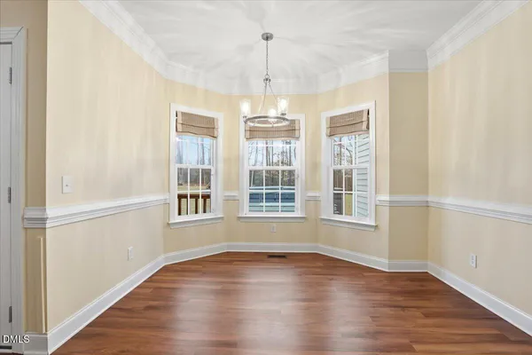 a kitchen with a sink cabinets and wooden floor