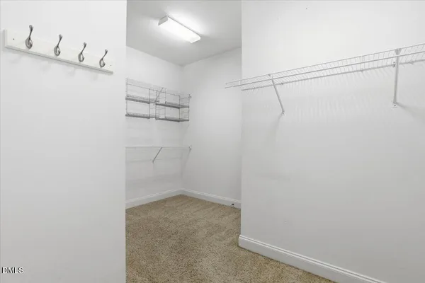 a white bath tub sitting in a bathroom and closet area