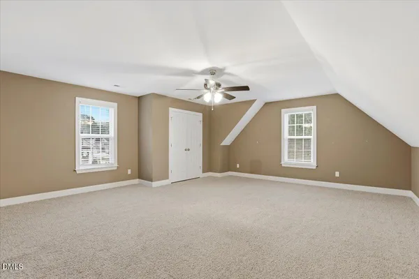 a view of an empty room with a ceiling fan